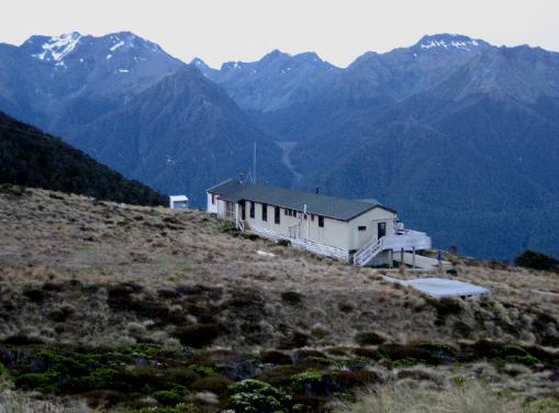 A view of Luxmore Hut with its mountain backdrop