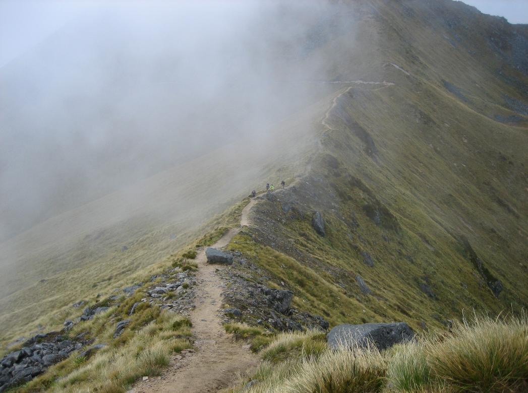 Dramatic view of a ridge walk with misty clouds moving in
