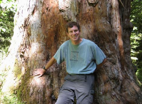 Bob standing in front of a 1,000 year old totara tree